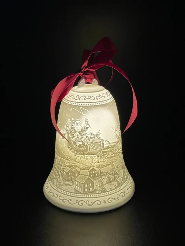 A bell with a red ribbon on it