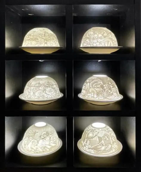 A series of six lamps with different designs on them.