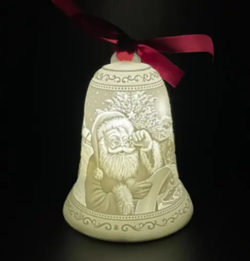 A lighted bell with santa claus on it.